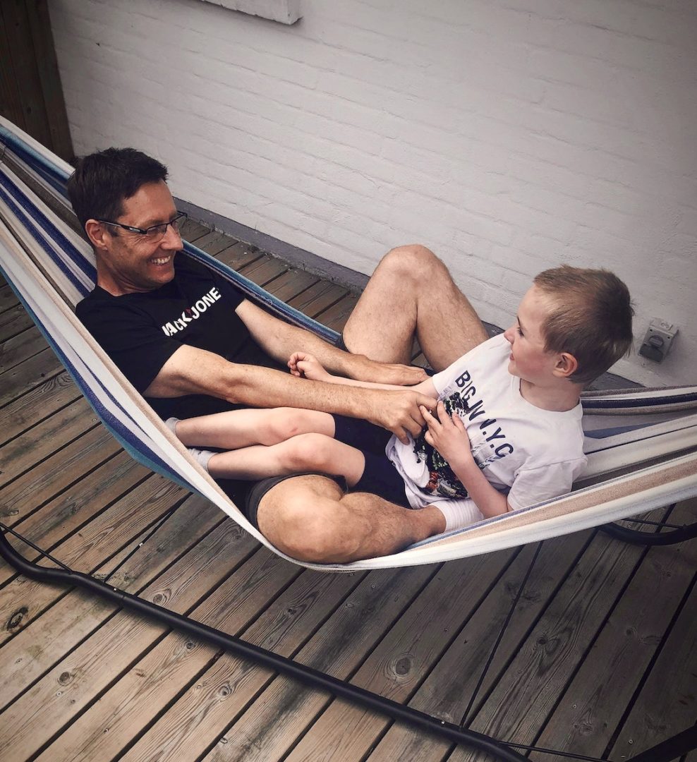 Happy Father and Son sitting on a Hammock