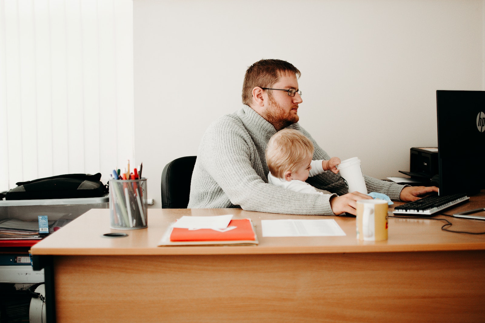 A Man Taking Care of His Son while Working